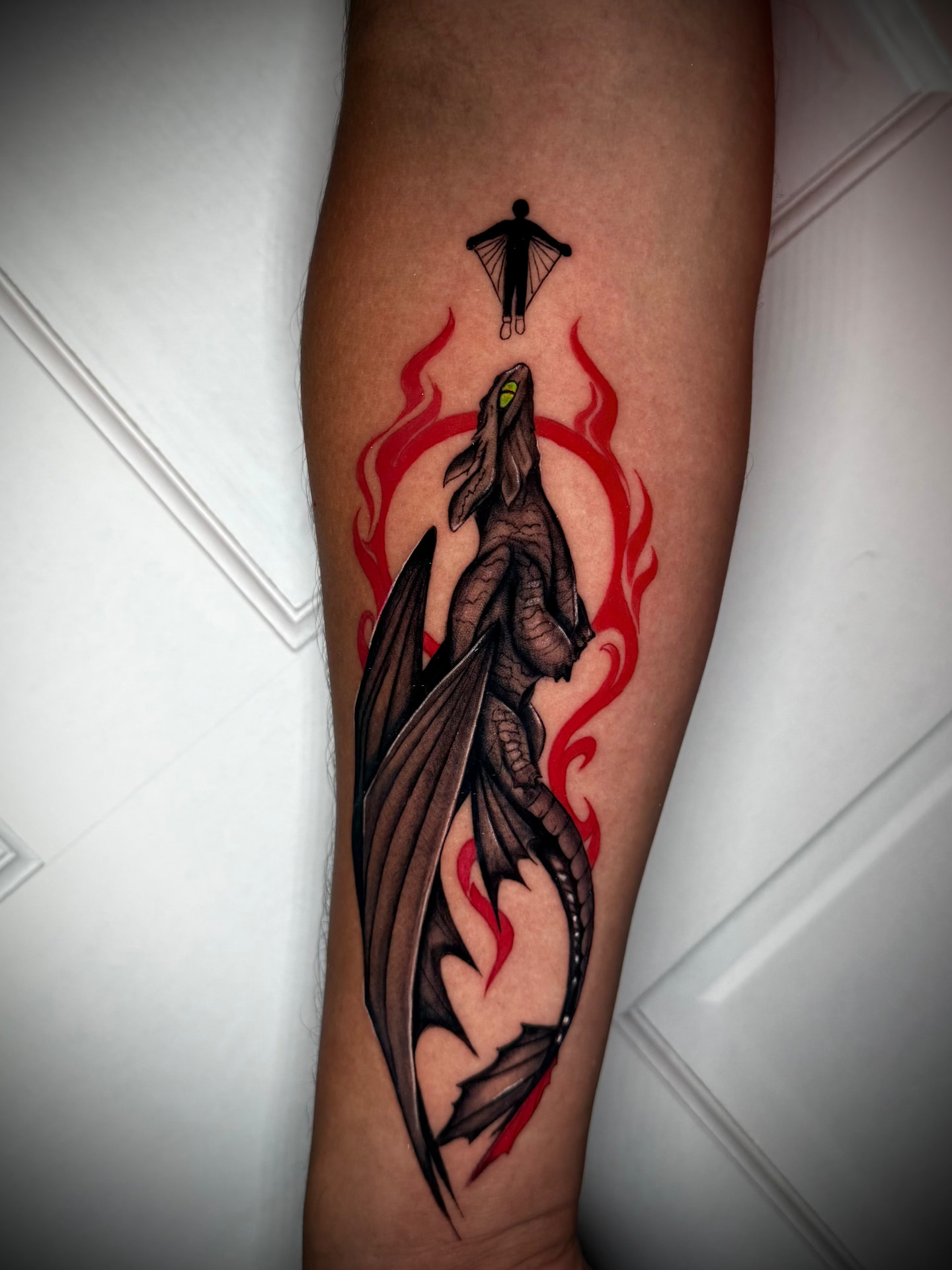 Dragon with red flames tattoo by Karen