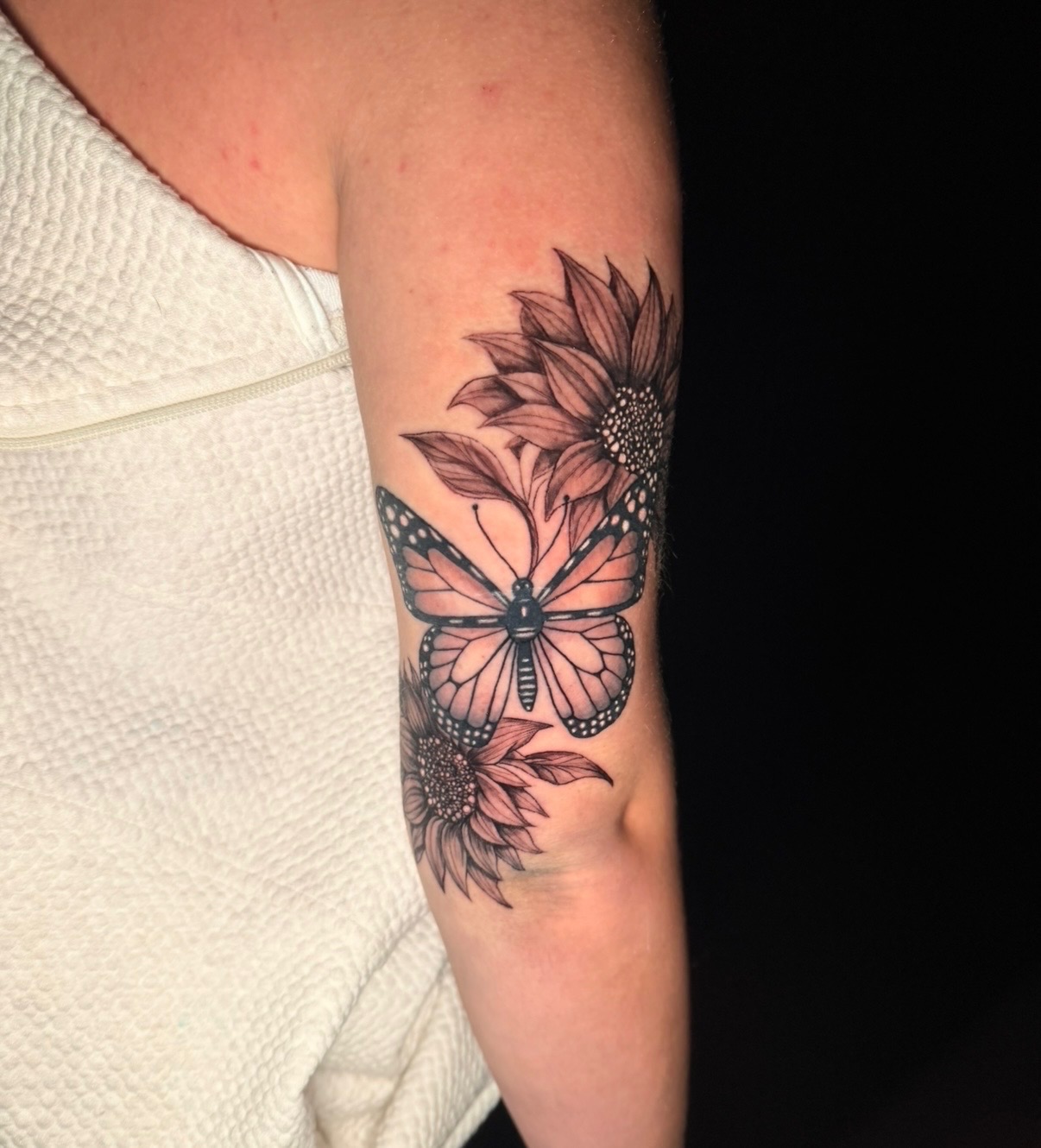 Black and grey butterfly and sunflowers tattoo by Quinn