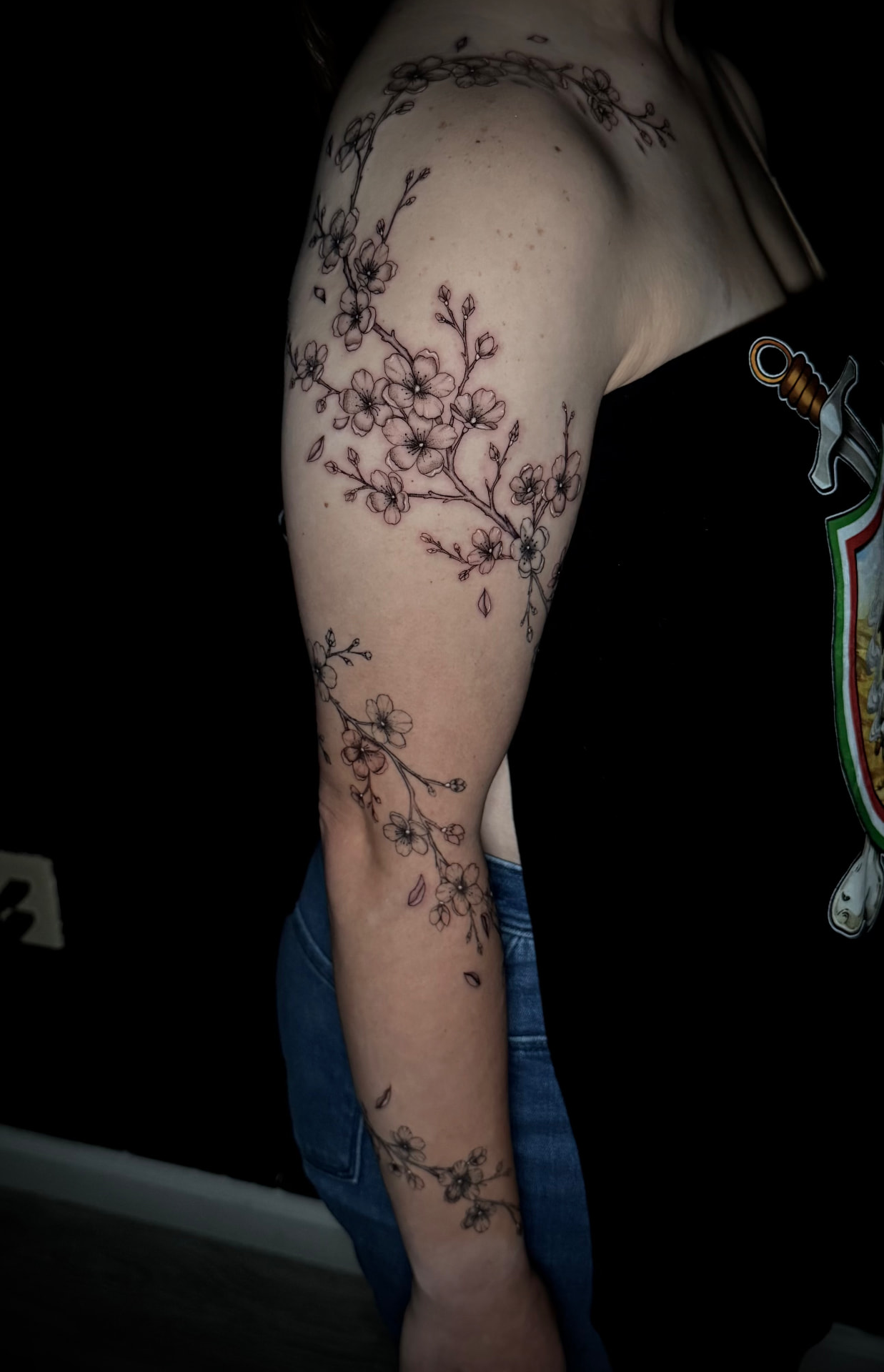 Cherry blossom shoulder and arm tattoo by Karen