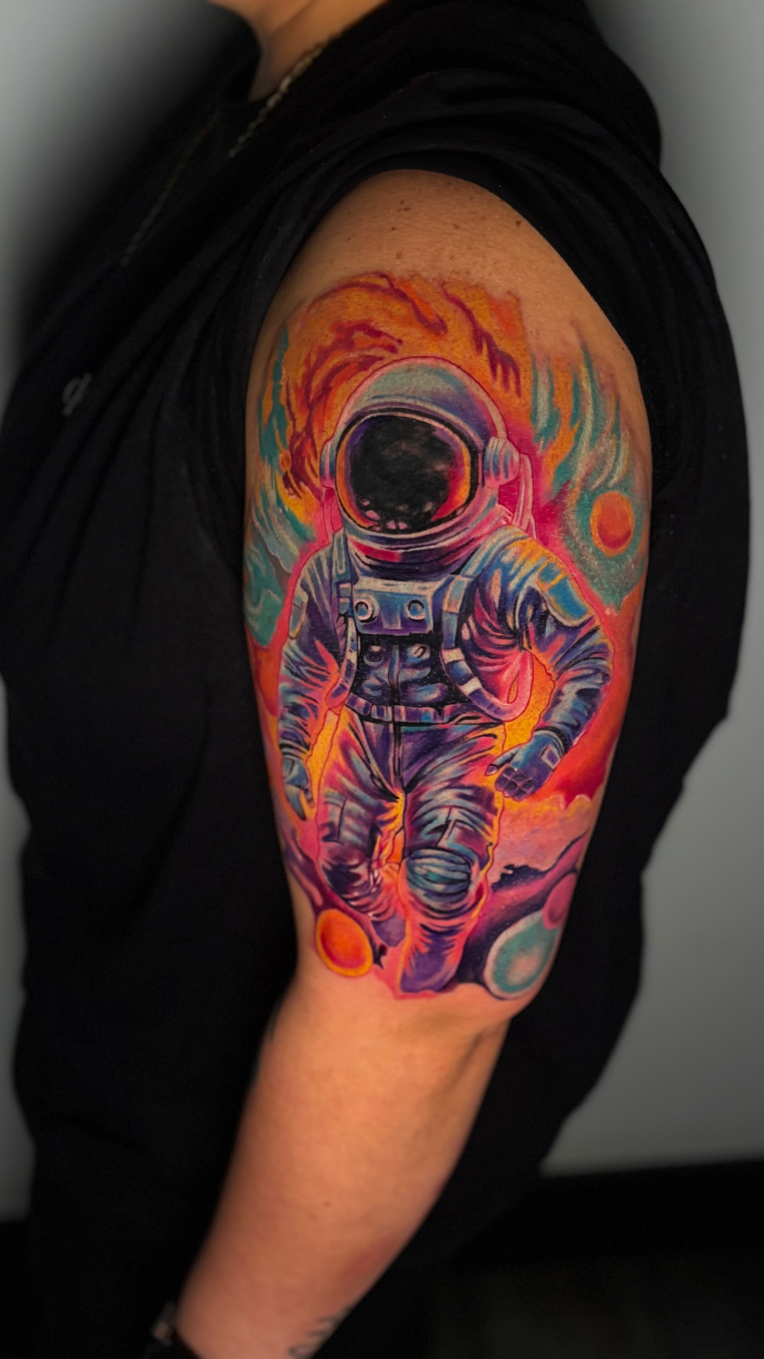Color astronaut arm tattoo