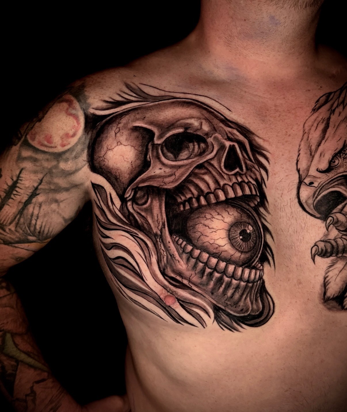 Black and grey skull and eyeball tattoo by Quinn