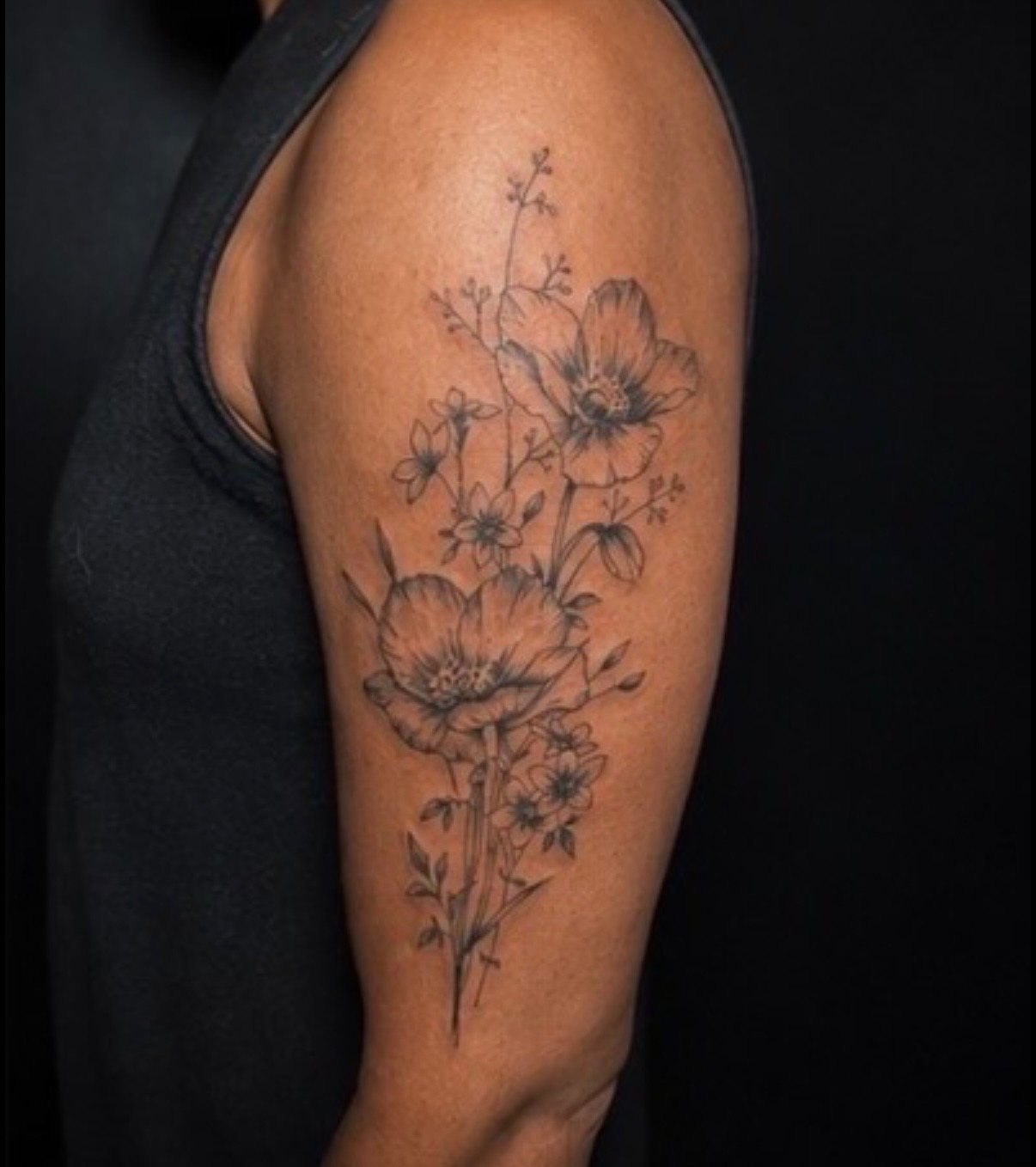 Fine line wildflower bouquet tattoo by Quinn
