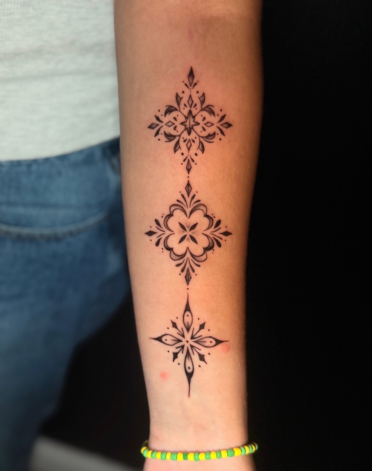 Fine line ornamental floral tattoos by Quinn