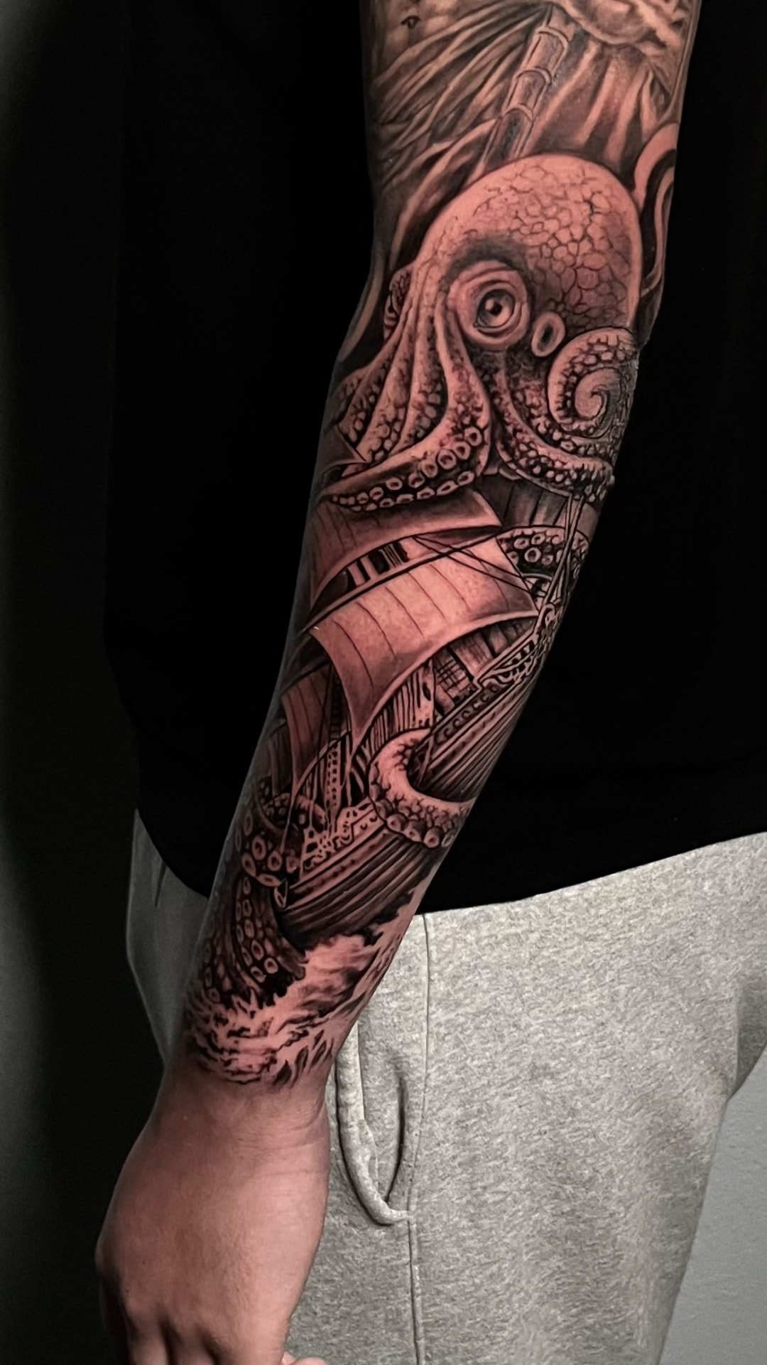 Black and grey kraken and sailing ship tattoo by Joey