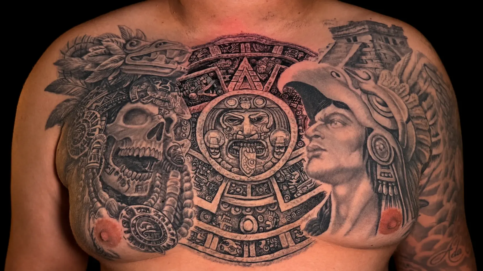 Black and grey Aztec chest tattoo by Dave
