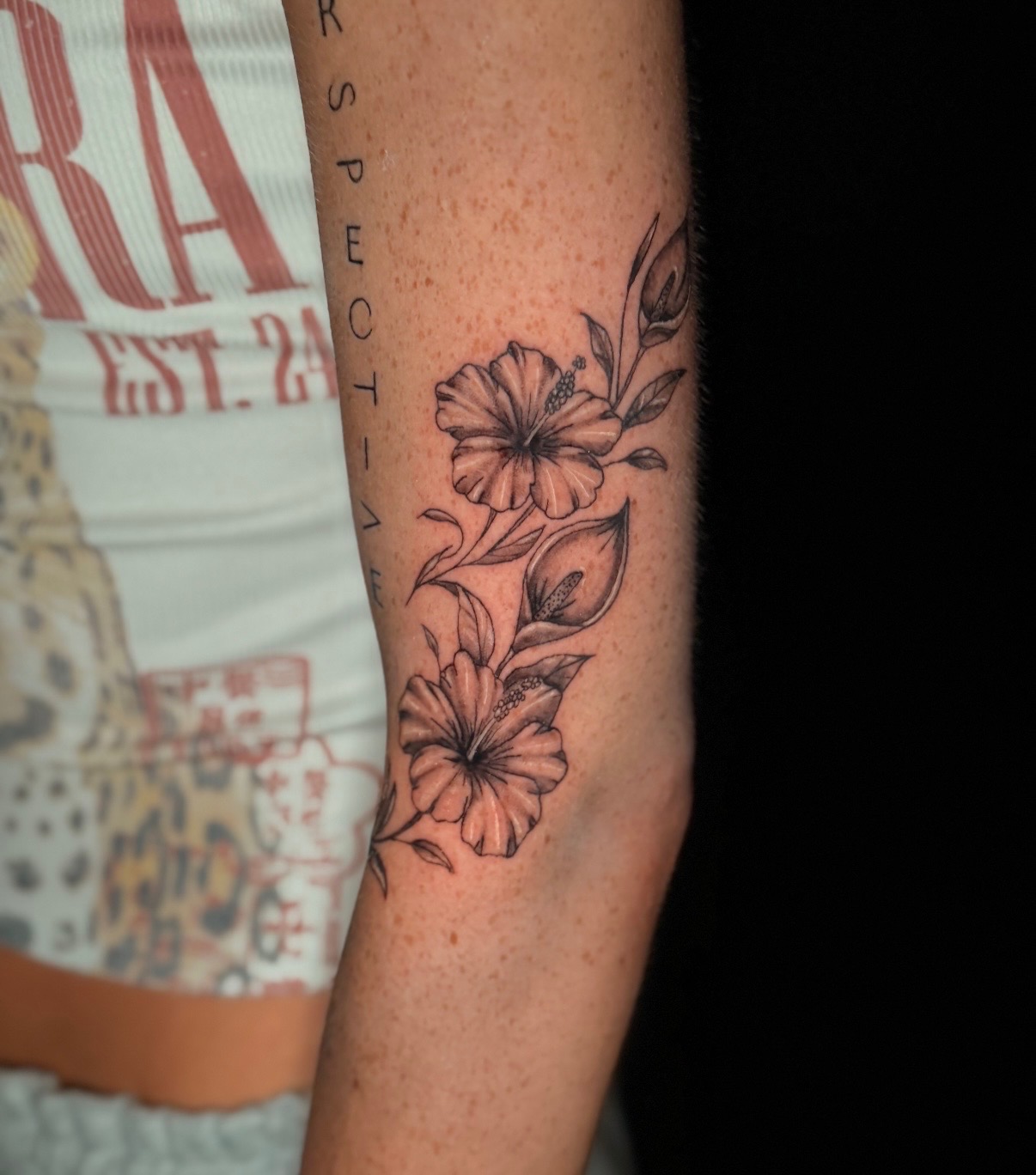 Fine line hibiscus and calla lily tattoo by Quinn