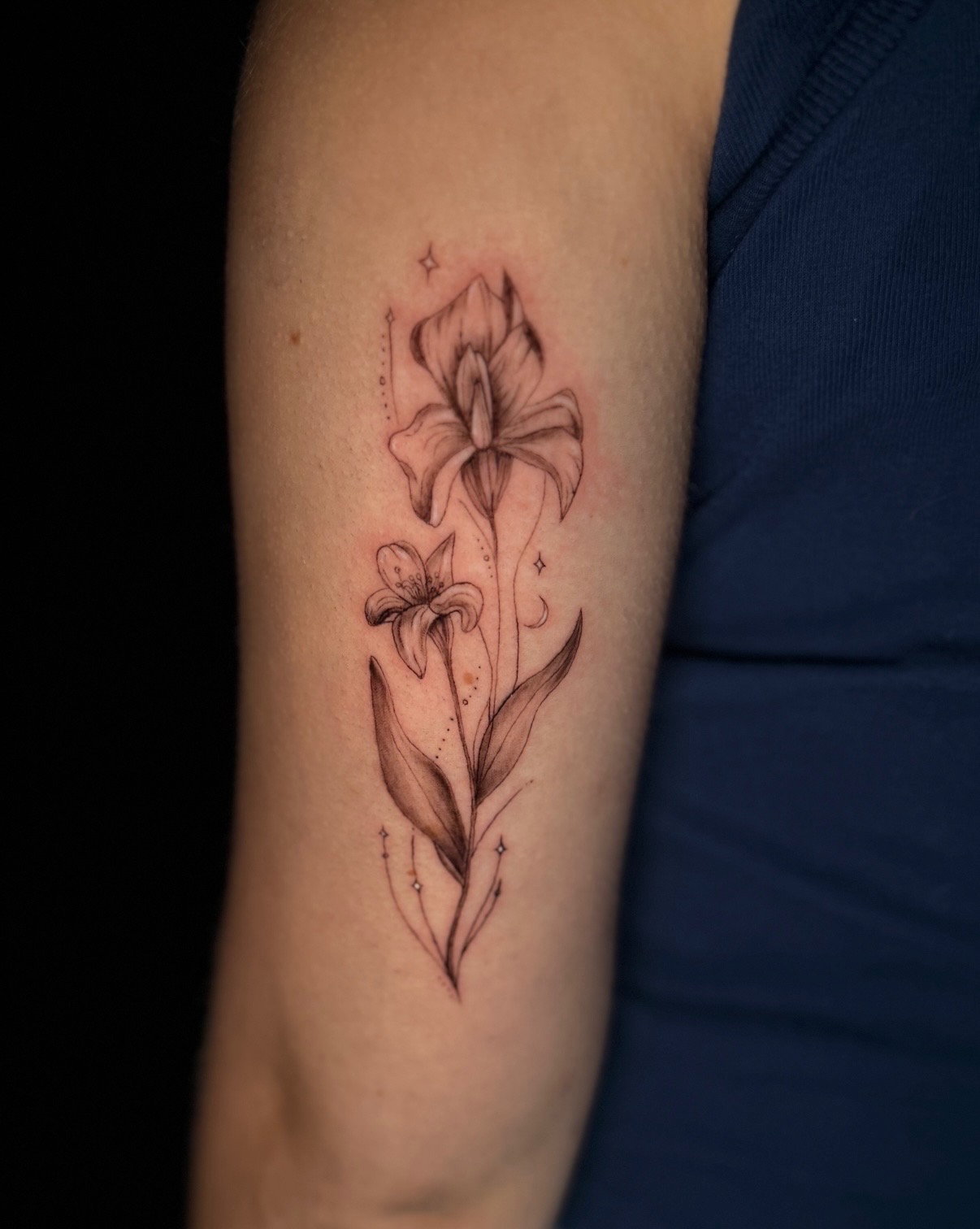 Fine line iris and lily tattoo by Quinn